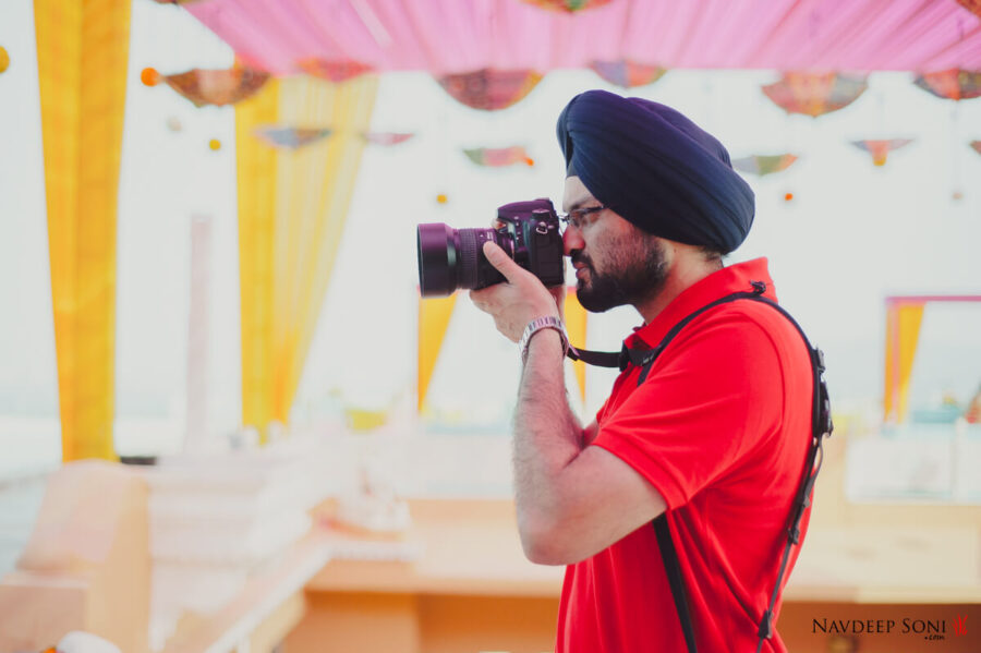 Navdeep Soni with a camera shooting a destination wedding